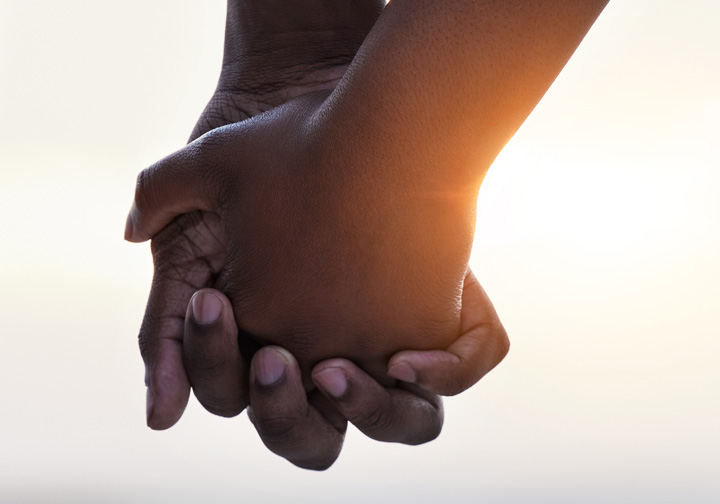 Two people holding hands