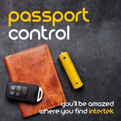 A leather passport case next to a battery and vehicle remote